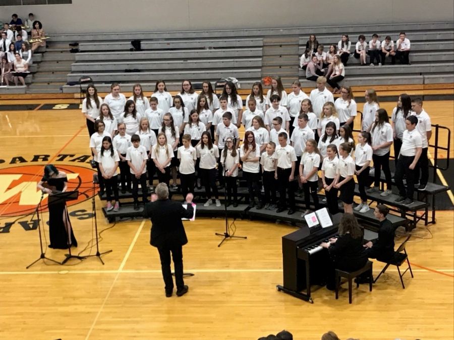 people wearing white shirts standing in risers